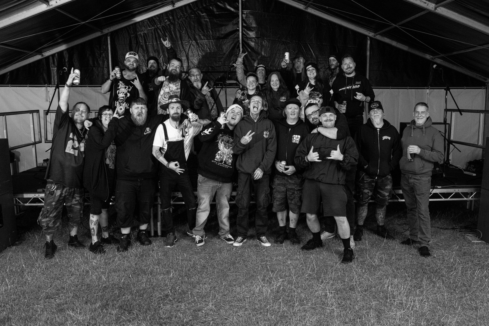 Photo of a silhouette of 2 dancers posing in front of a red curtain.